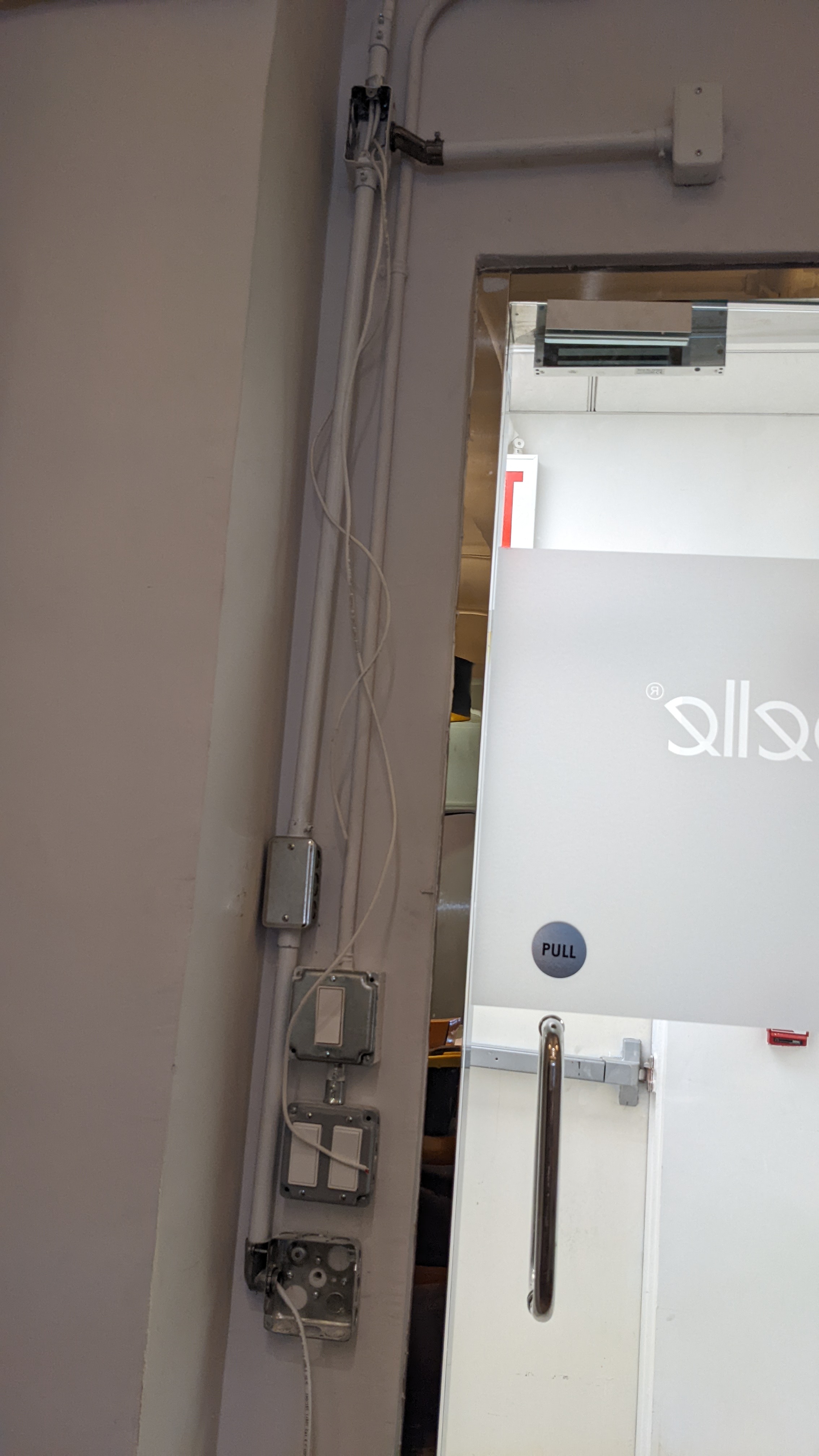 Access control hub and reader mounted beside an office entry door