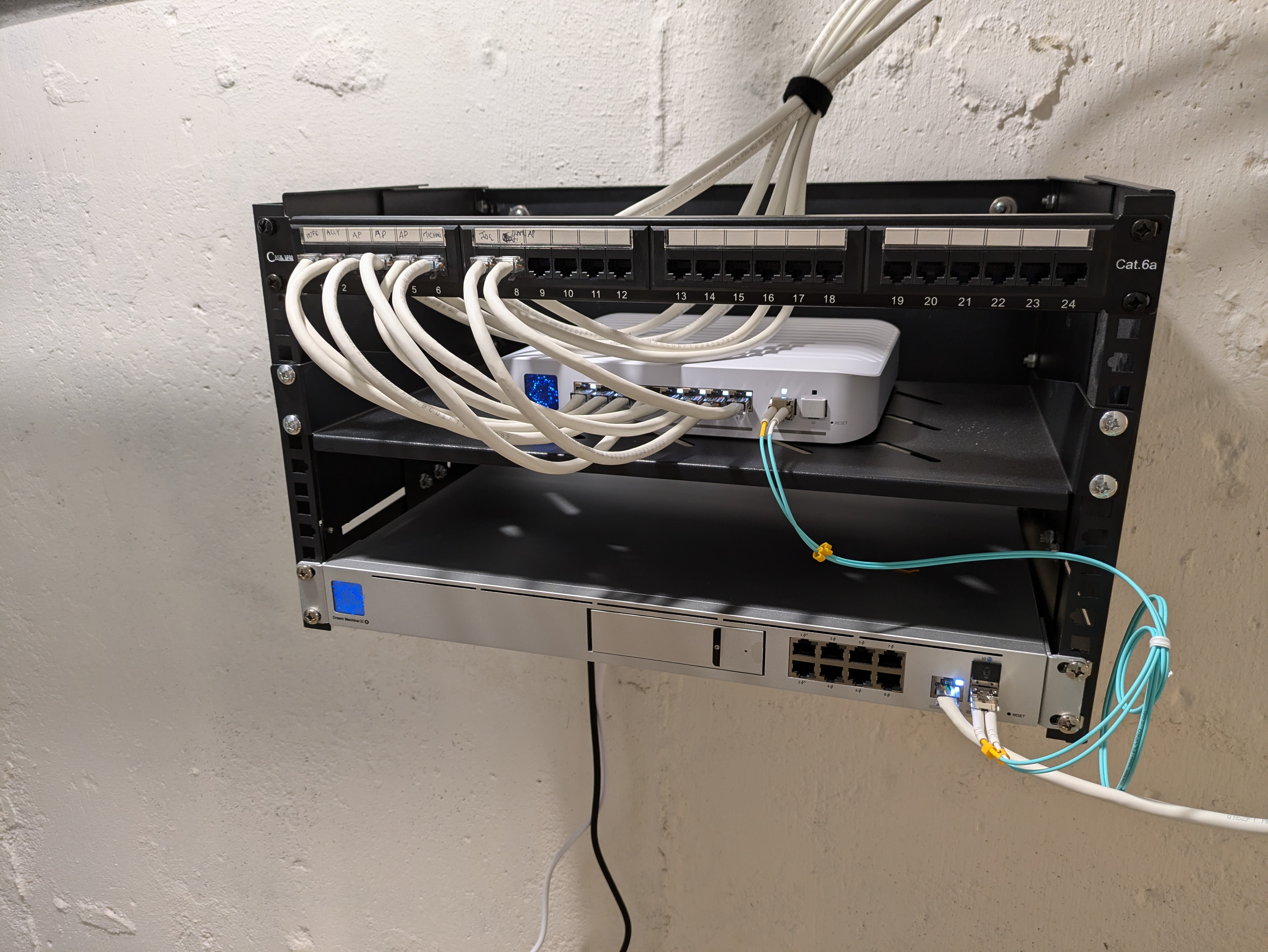 Finished residential network rack with patch panel, router, and switch cleanly cabled