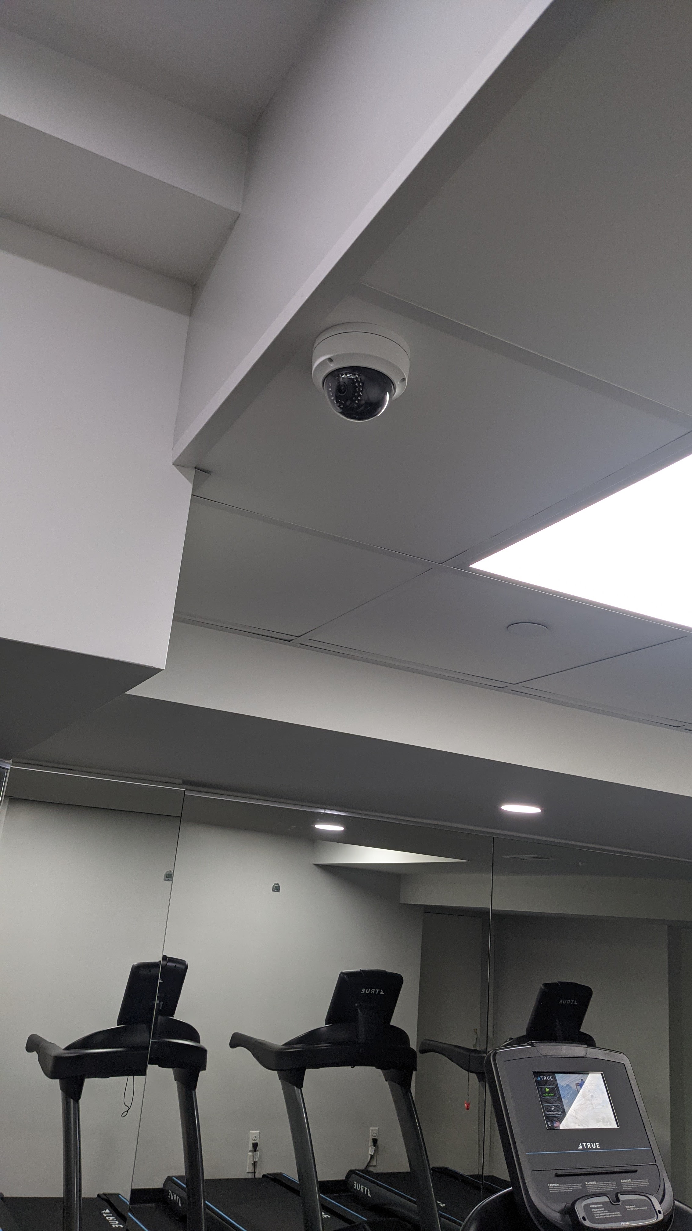 Security camera installed in a building's fitness amenity space