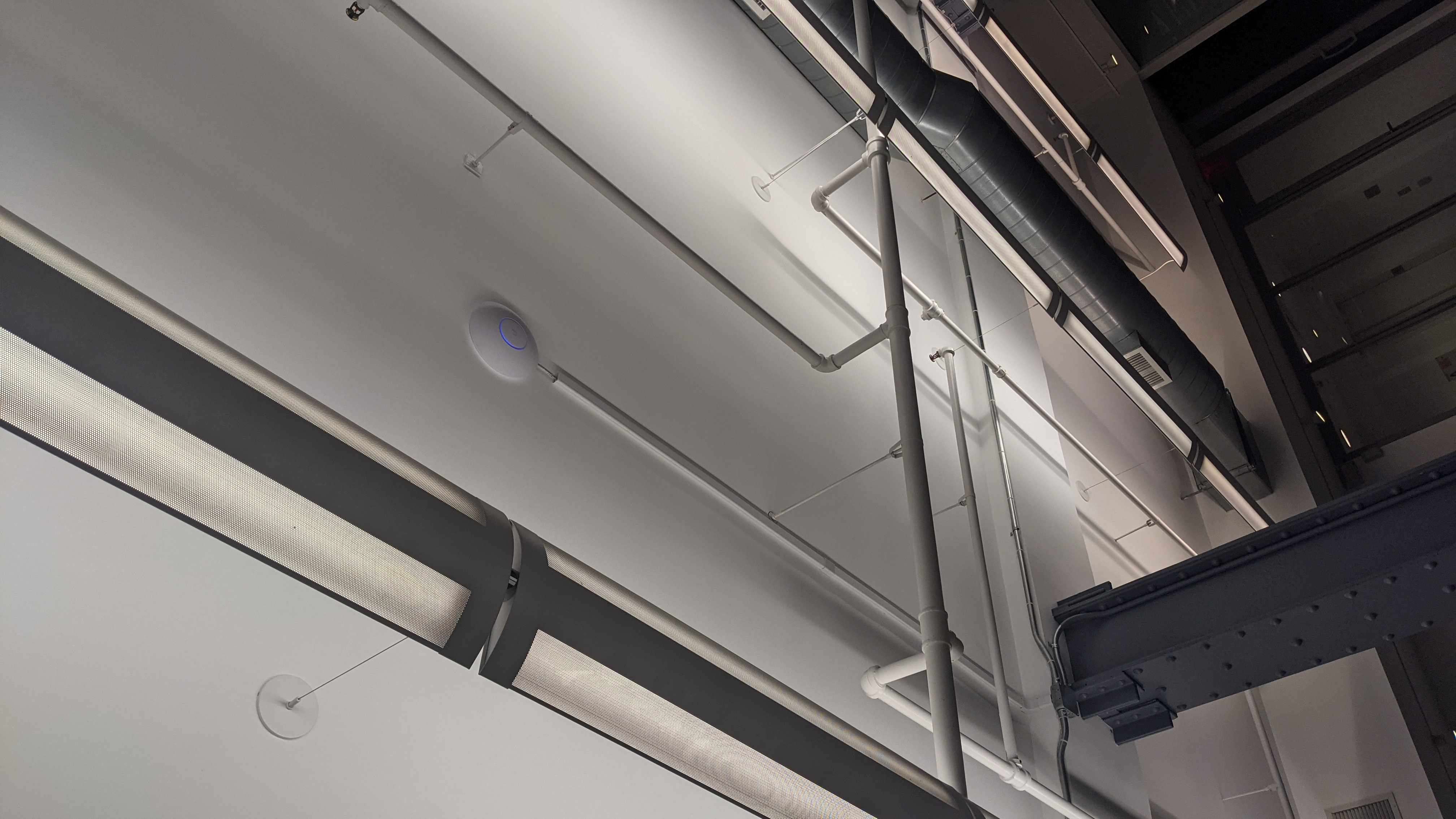 Ceiling-mounted wireless access point installed in an office space