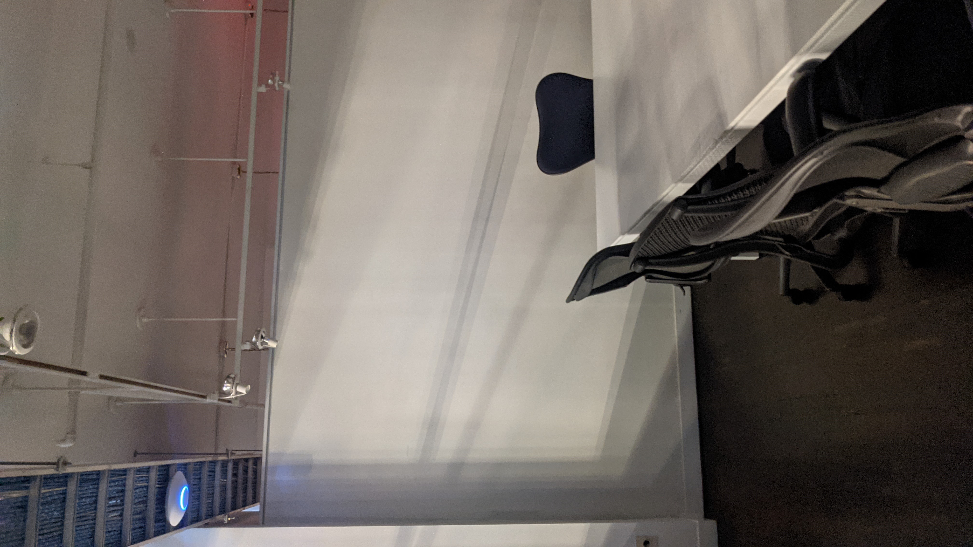 Ceiling-mounted wireless access point installed in an office corridor