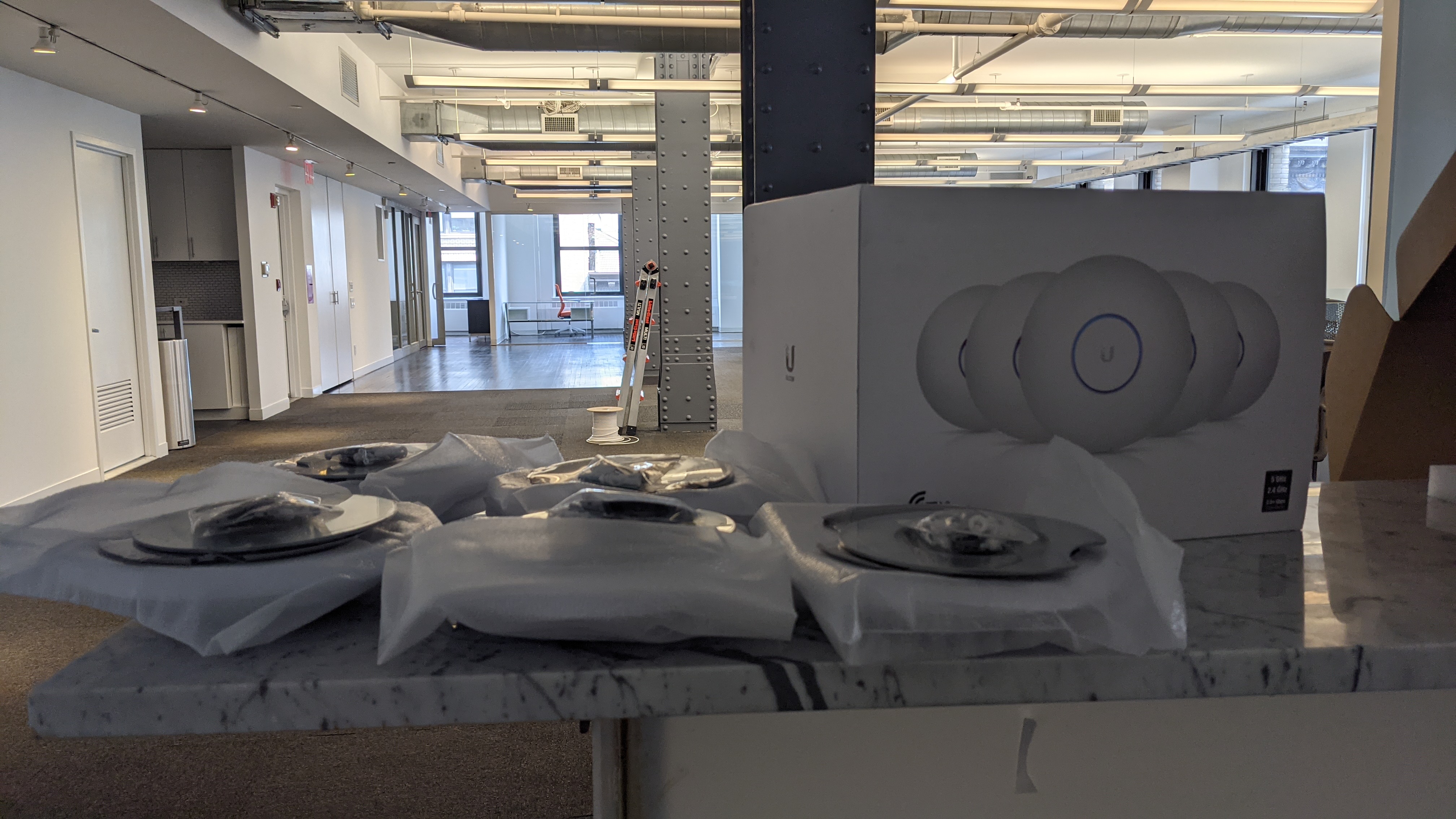 Unifi wireless access points and networking equipment ready for an office install