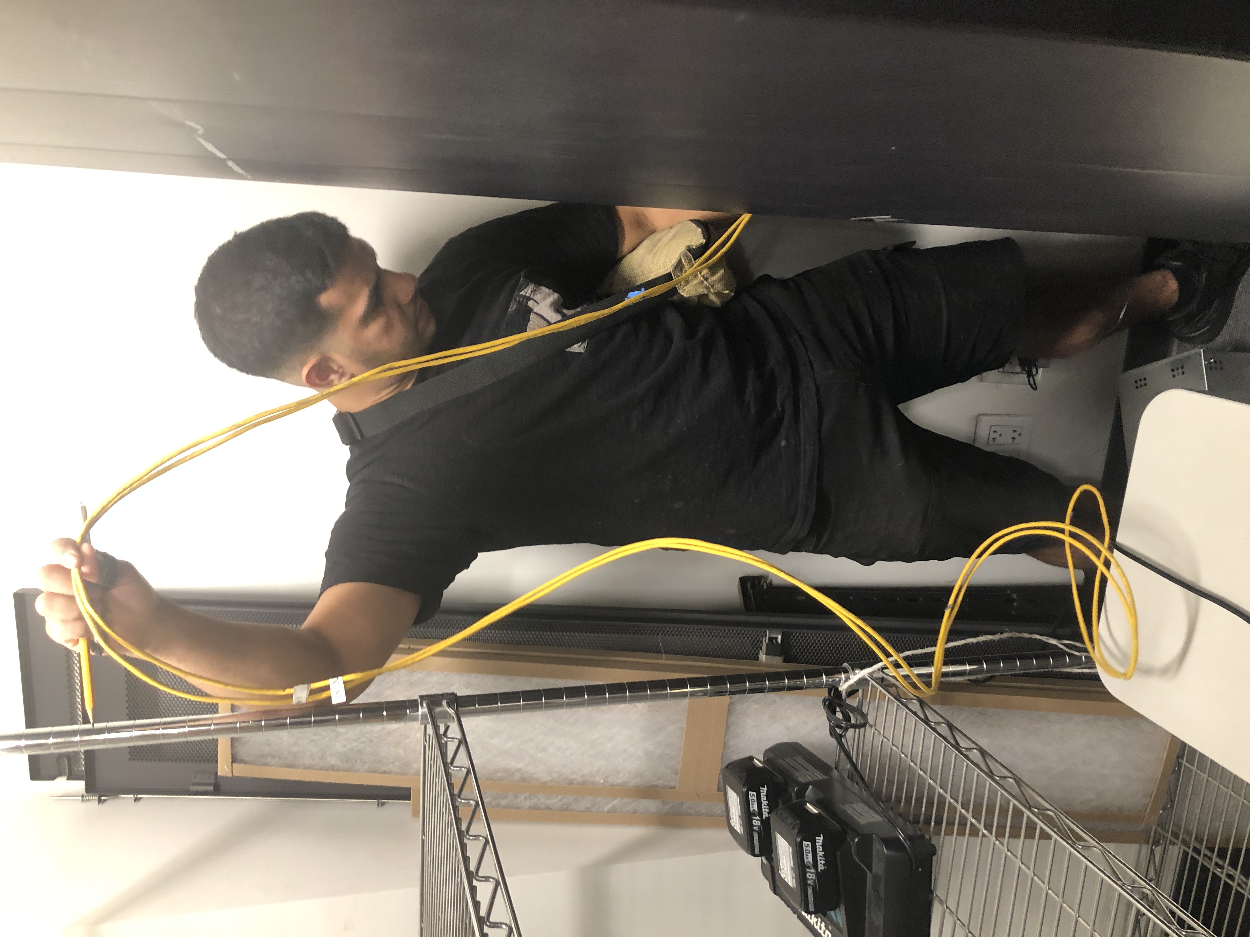 Prelinium technician managing fiber cabling during an installation