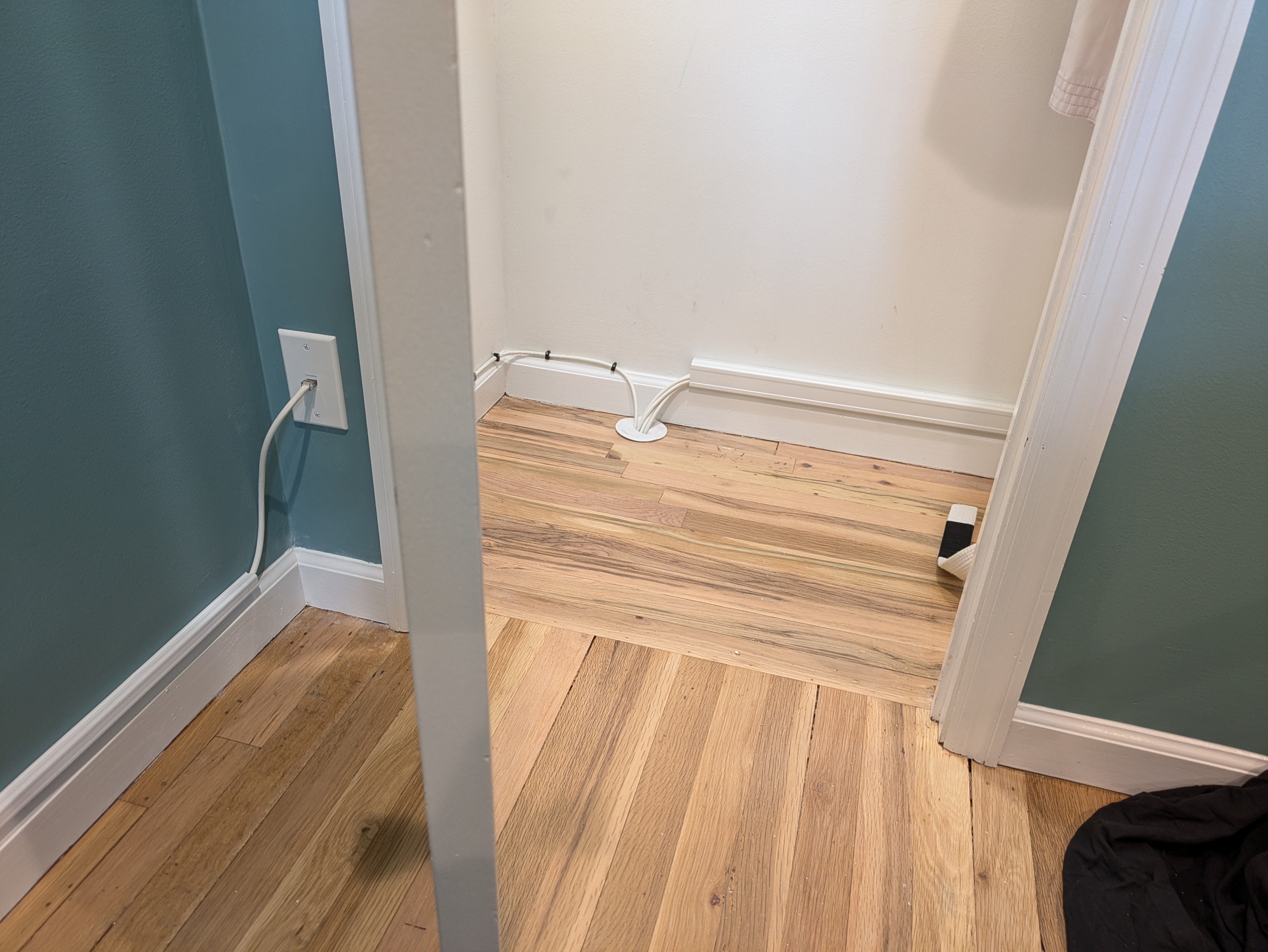 Network cable routed into a closet with a floor-mount cable grommet